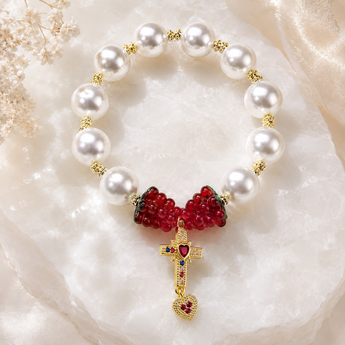 White pearl Catholic prayer bracelet with floral fruit inspired details, elegant beads and cross charm for prayer and meaningful faith gifts.