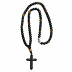 Handmade men’s black Catholic rosary with matte black beads, tiger-eye accents, dark metal details, and black crucifix.