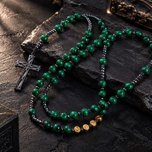 Green Stone Rosary featuring rich green swirl beads, dark metallic accents, gold letter beads, and a silver cross pendant.
