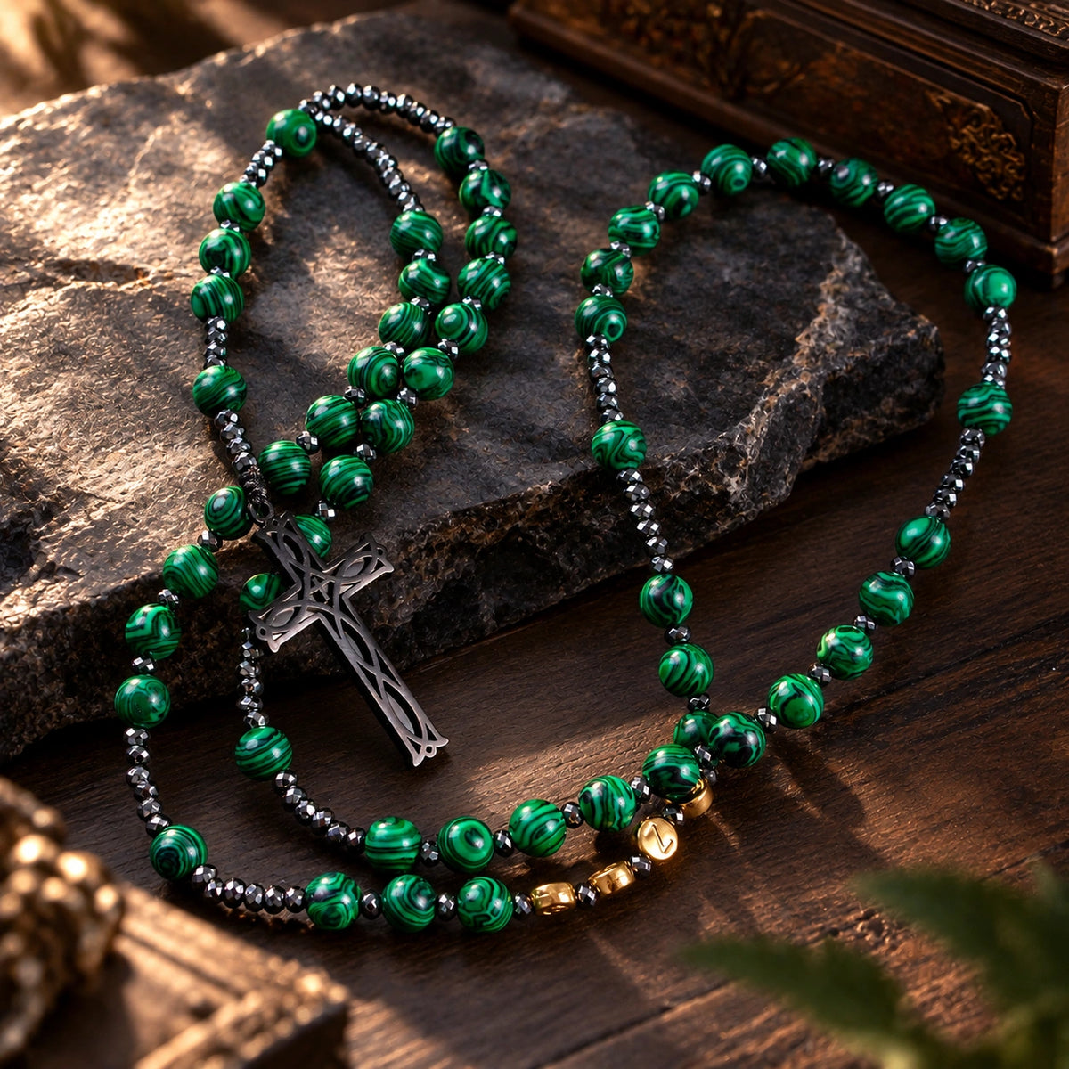Men’s Catholic prayer beads with green natural stone-style patterns, dark metal spacer beads, and handmade rosary details.