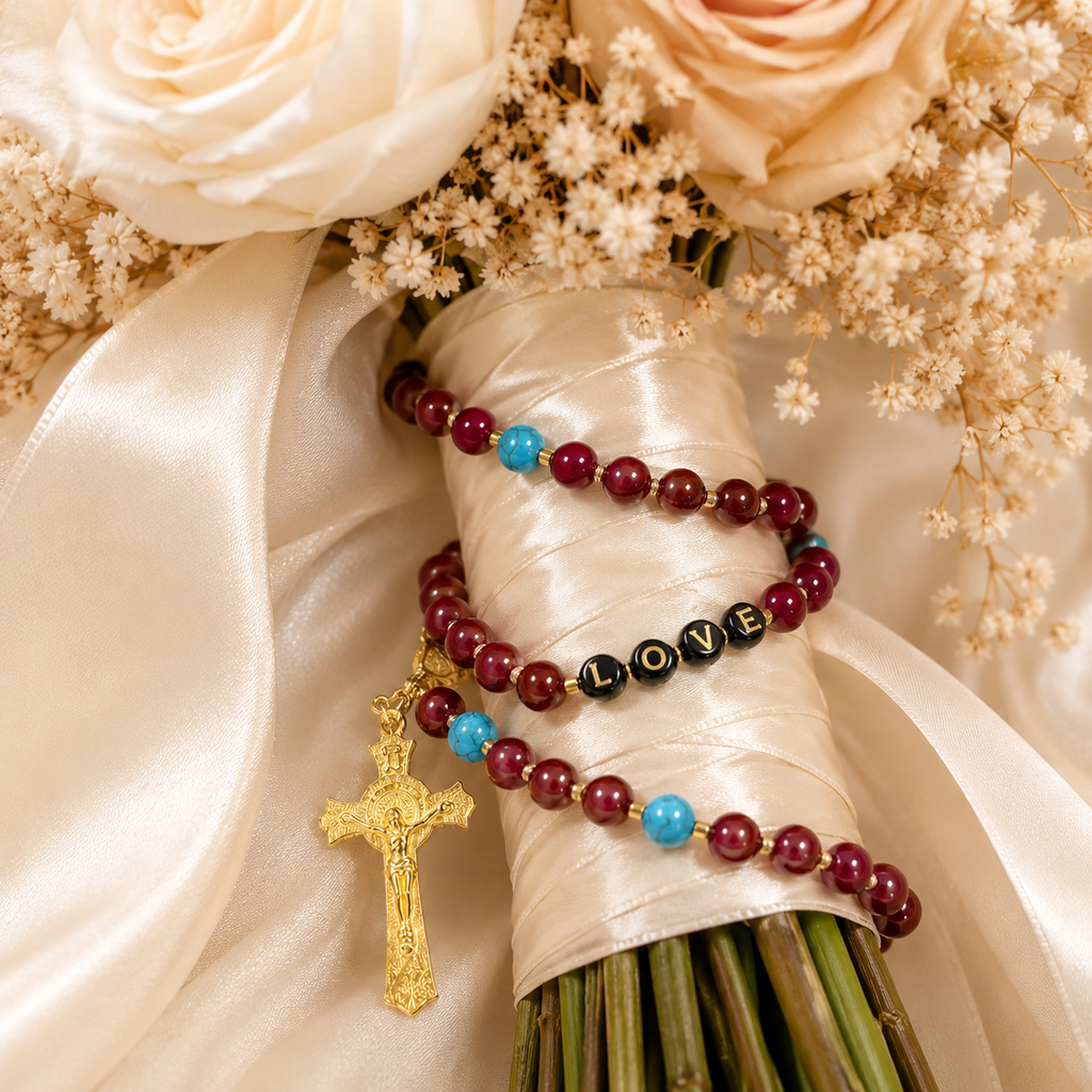 Red wedding rosary for bride with gold crucifix, turquoise accent beads, and LOVE letter beads wrapped around a bridal bouquet