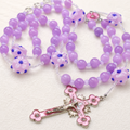 Lavender floral Catholic rosary with purple beads, flower glass accents, and pink crucifix pendant for daily prayer.