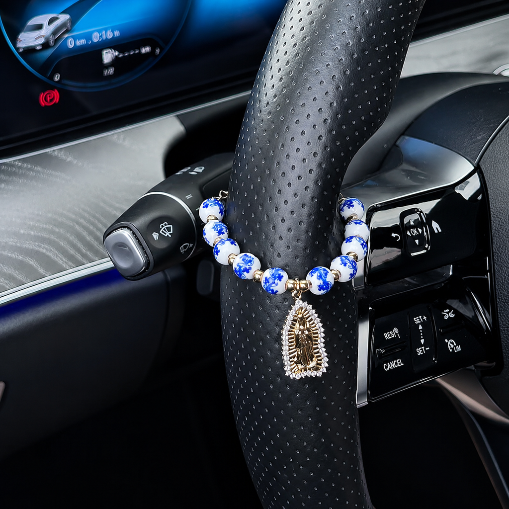 Blue and white Catholic car rosary charm with floral ceramic beads and gold cross pendant, a handcrafted faith decoration for car interiors.
