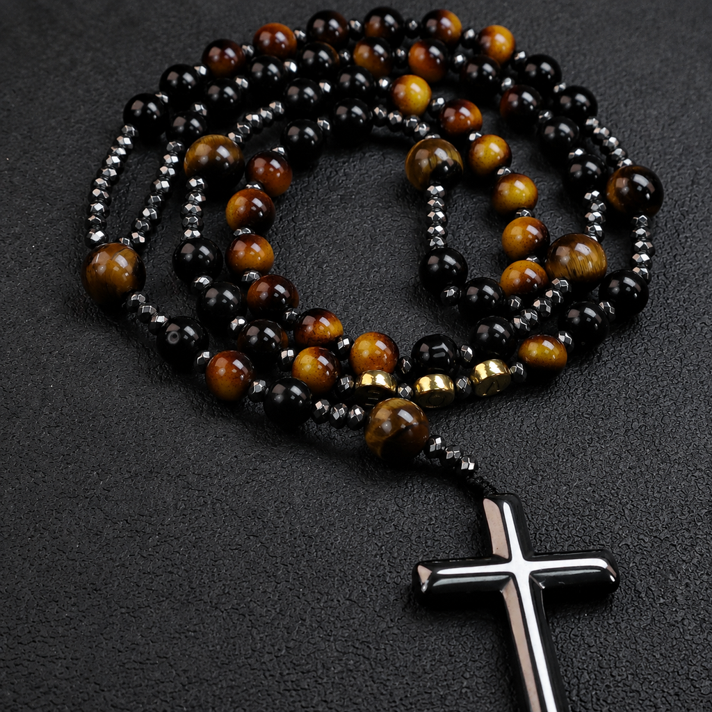 Men's black Catholic rosary with natural stone beads, silver crucifix pendant, and masculine faith design on a dark background.