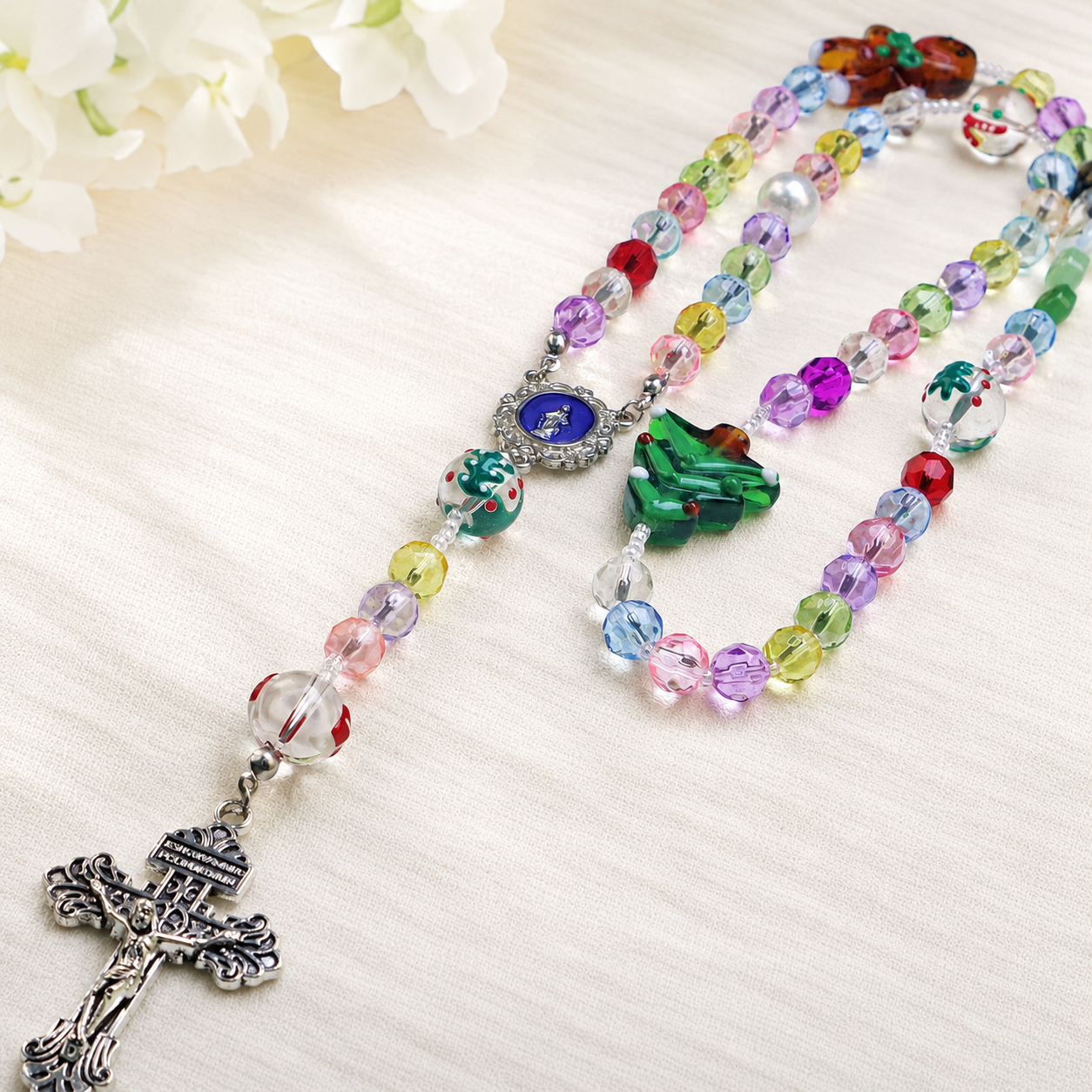Colorful handmade rosary for kids with rainbow glass beads, religious charms, and a traditional crucifix for daily prayer and devotion.