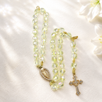 Crystal Catholic prayer bracelet with translucent beads, religious medal, and cross charm designed as meaningful faith jewelry for women.