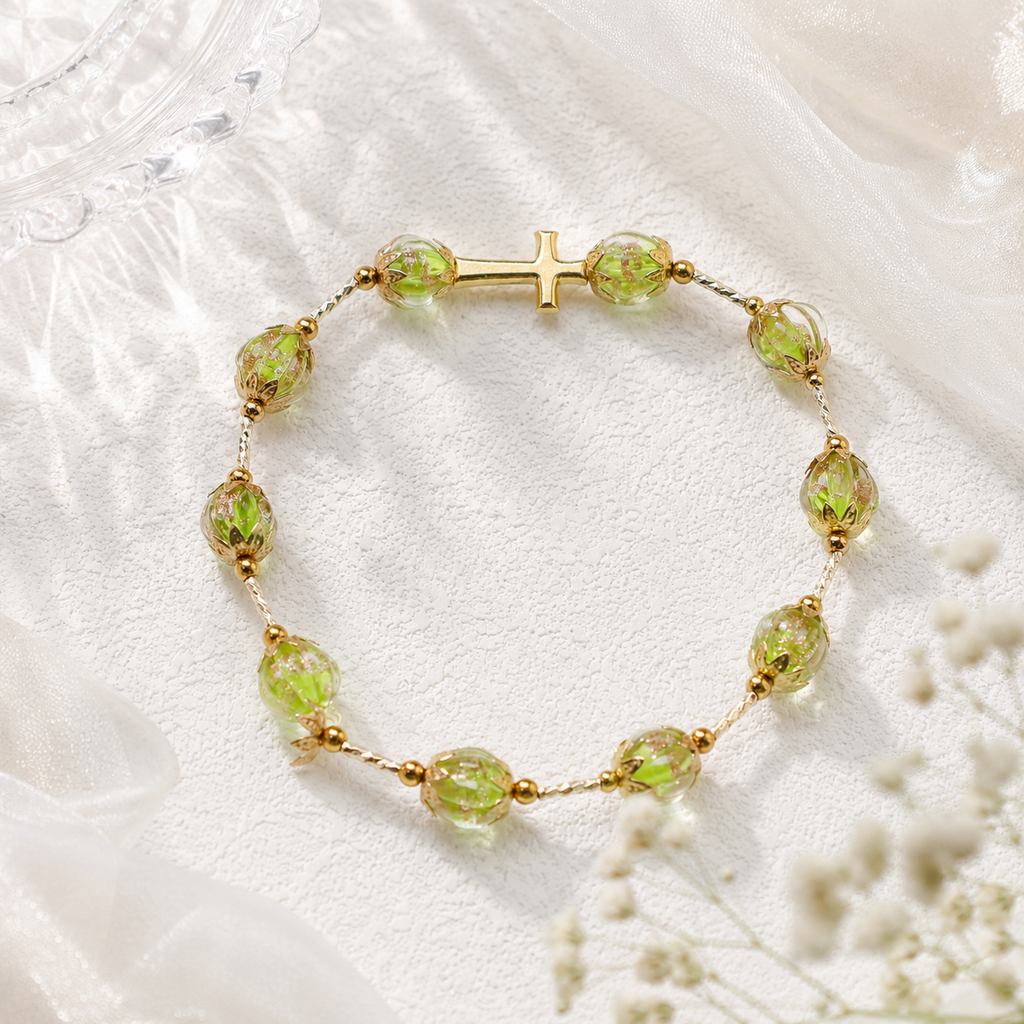 Green glass bead Catholic prayer bracelet with handmade design and gold cross charm, a unique Christian jewelry piece for daily prayer.