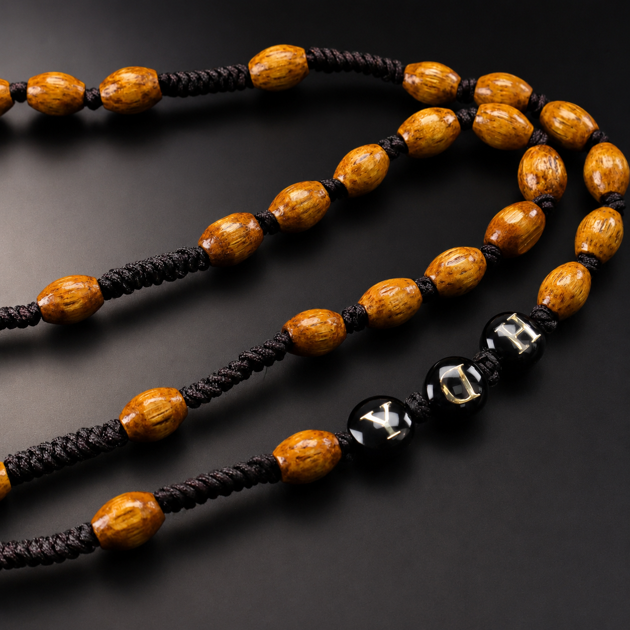 Detailed view of brown wooden-style rosary beads with dark cord knots and traditional Catholic craftsmanship.