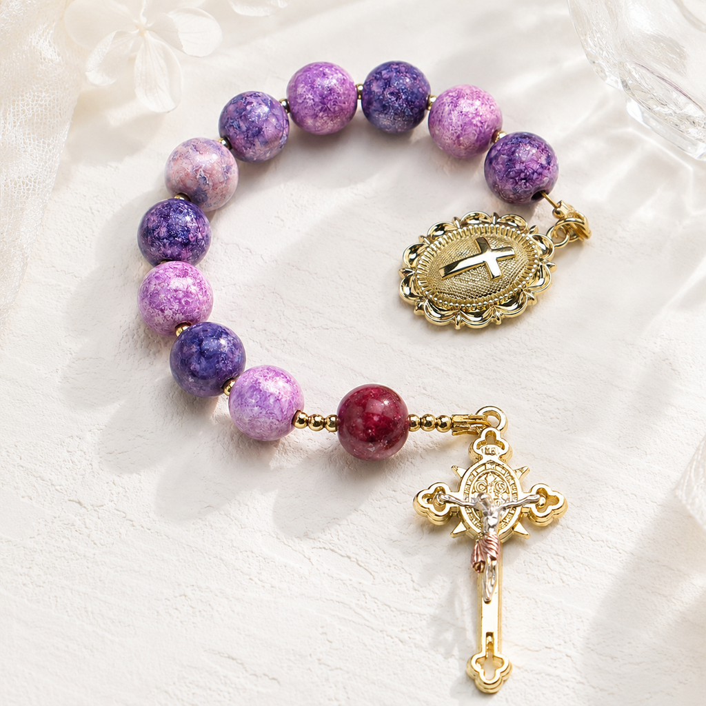Purple Catholic pocket rosary with natural stone beads, decorative religious charms, and crucifix for prayer, meditation, and faith keepsake.