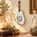 Catholic wall hanging displayed in a prayer corner with candle, rosary, flowers, and Virgin Mary statue for home devotion.