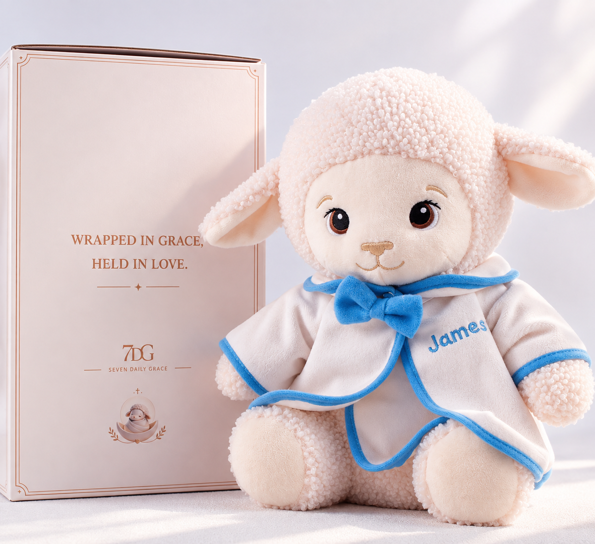 Baptism lamb plush with blue-trimmed white outfit and matching bow, personalized for a baby boy's christening.