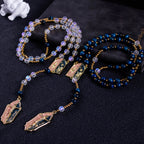 Handmade Catholic wedding rosary set with deep blue and translucent beads, gold crucifixes, and Marian centerpieces for bride and groom.