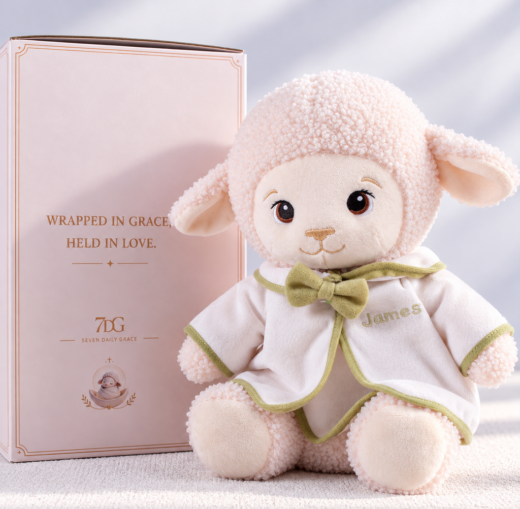 Baptism lamb plush with sage-green trim and matching bow on its white ceremonial outfit.