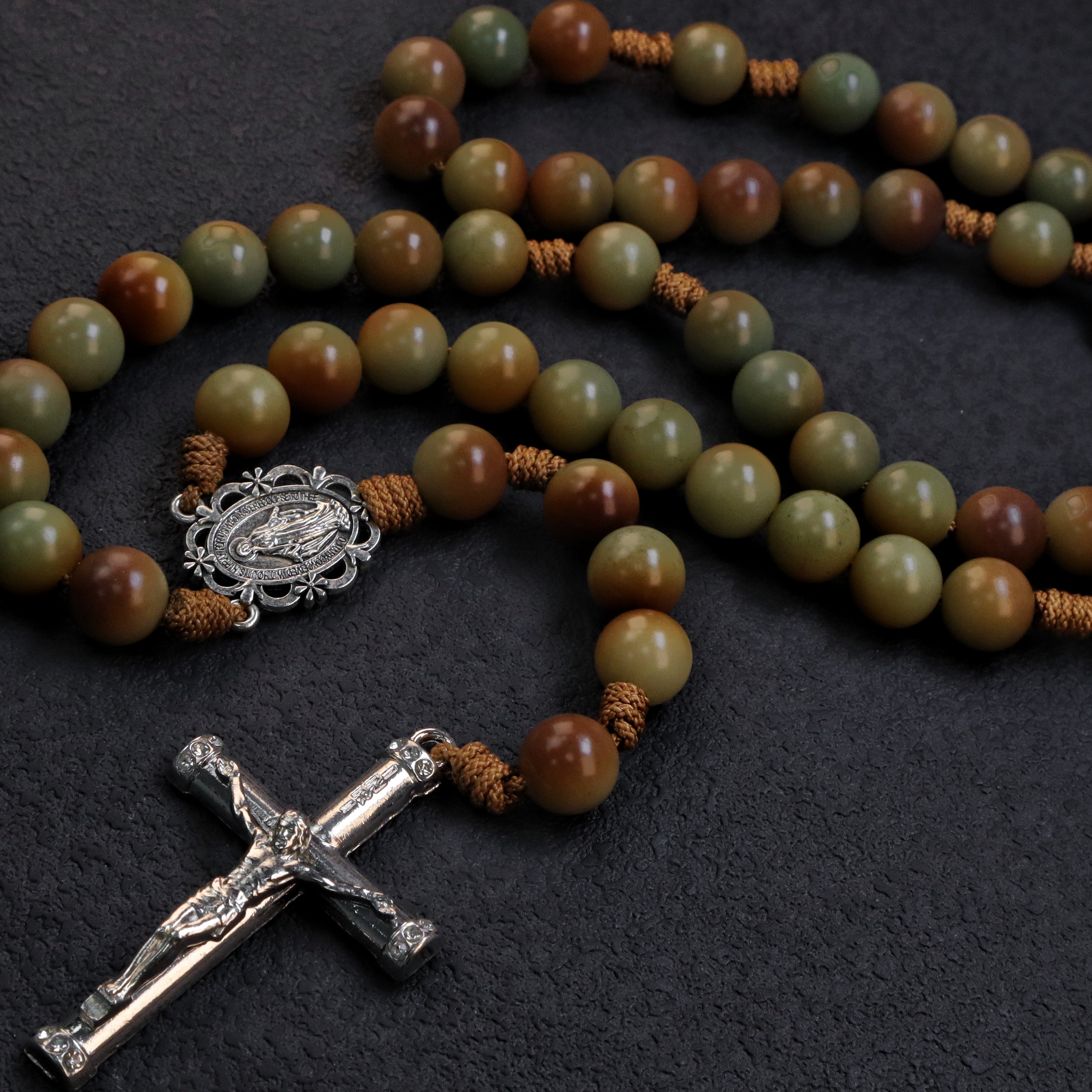 Men's earth tone Catholic rosary with natural stone beads, silver crucifix, and traditional handmade design for daily prayer.