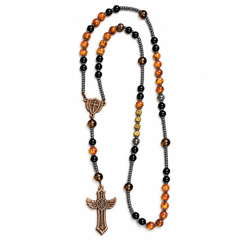 Handmade men’s Catholic rosary with black beads, UV color-changing amber accents, dark spacers, and bronze crucifix.