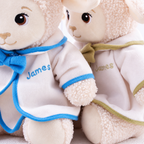 Personalized baptism lamb plush wearing a white ceremonial outfit with custom embroidery for a child's christening.