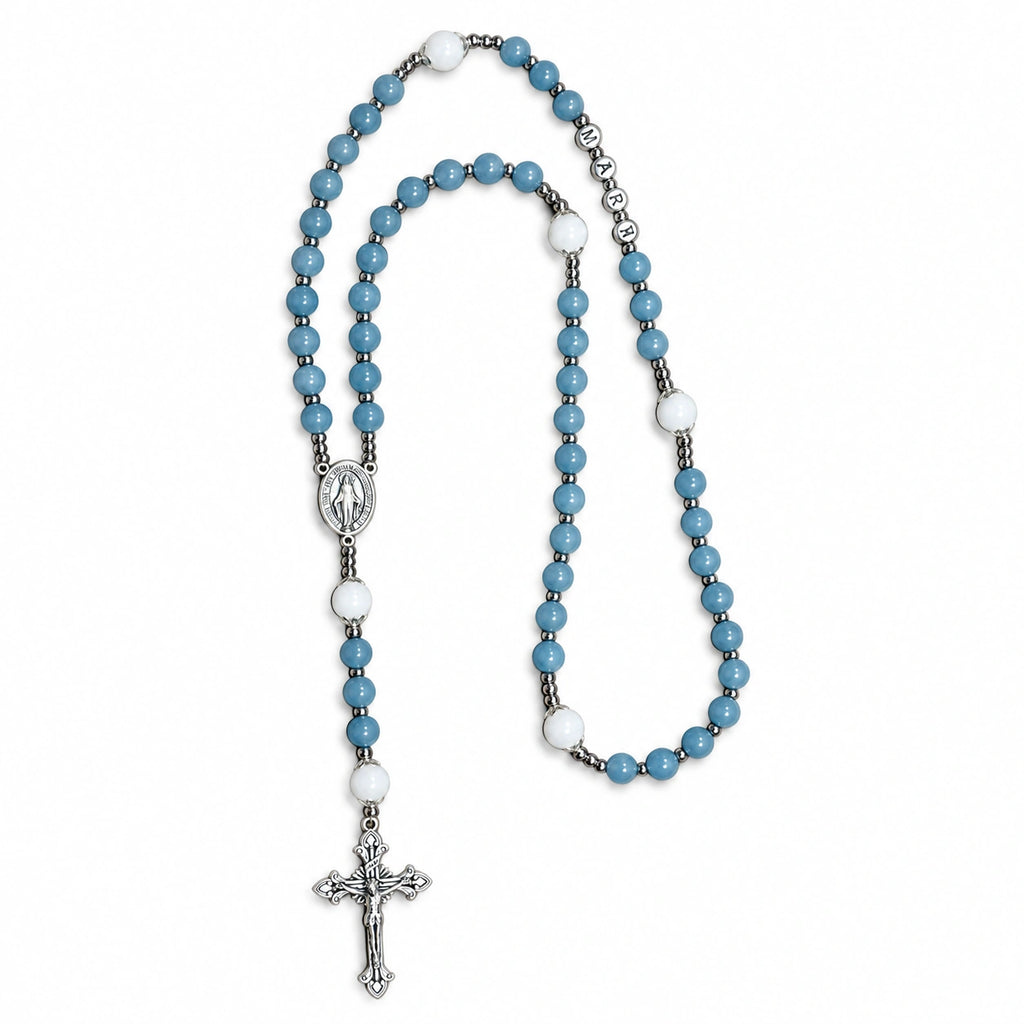 Handmade blue Catholic rosary with soft blue beads, white accents, Marian centerpiece, and silver crucifix.