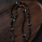 Masculine Catholic rosary gift set featuring black beads, black crucifix, gift box, pouch, and faith card, ideal for a groom, husband, or religious wedding gift.