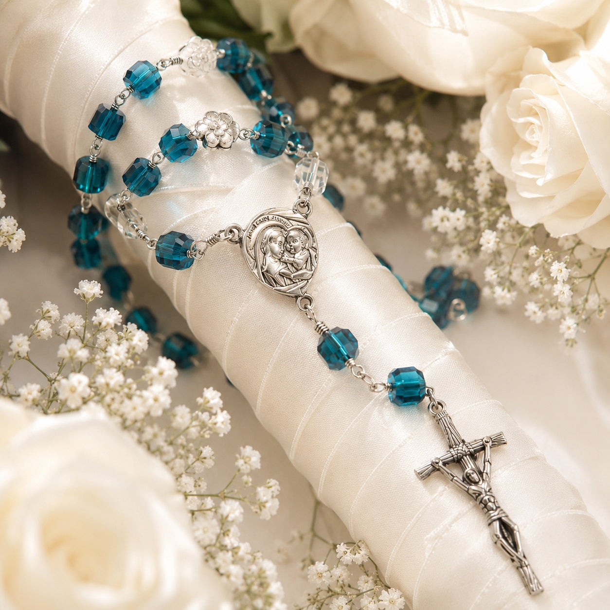 Close-up view of handmade blue Catholic rosary beads featuring crystal details, silver crucifix, and delicate prayer bead design for a bride wedding gift.