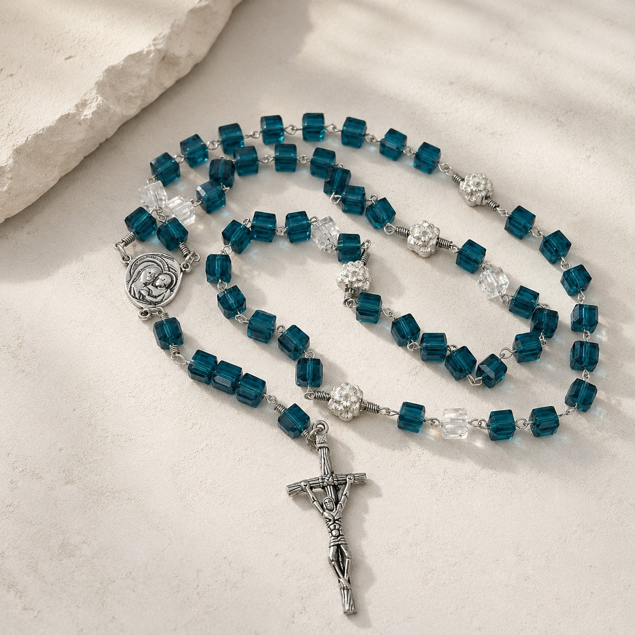 Elegant blue crystal rosary for baptism, First Communion, or confirmation, featuring a Virgin Mary medal and silver crucifix