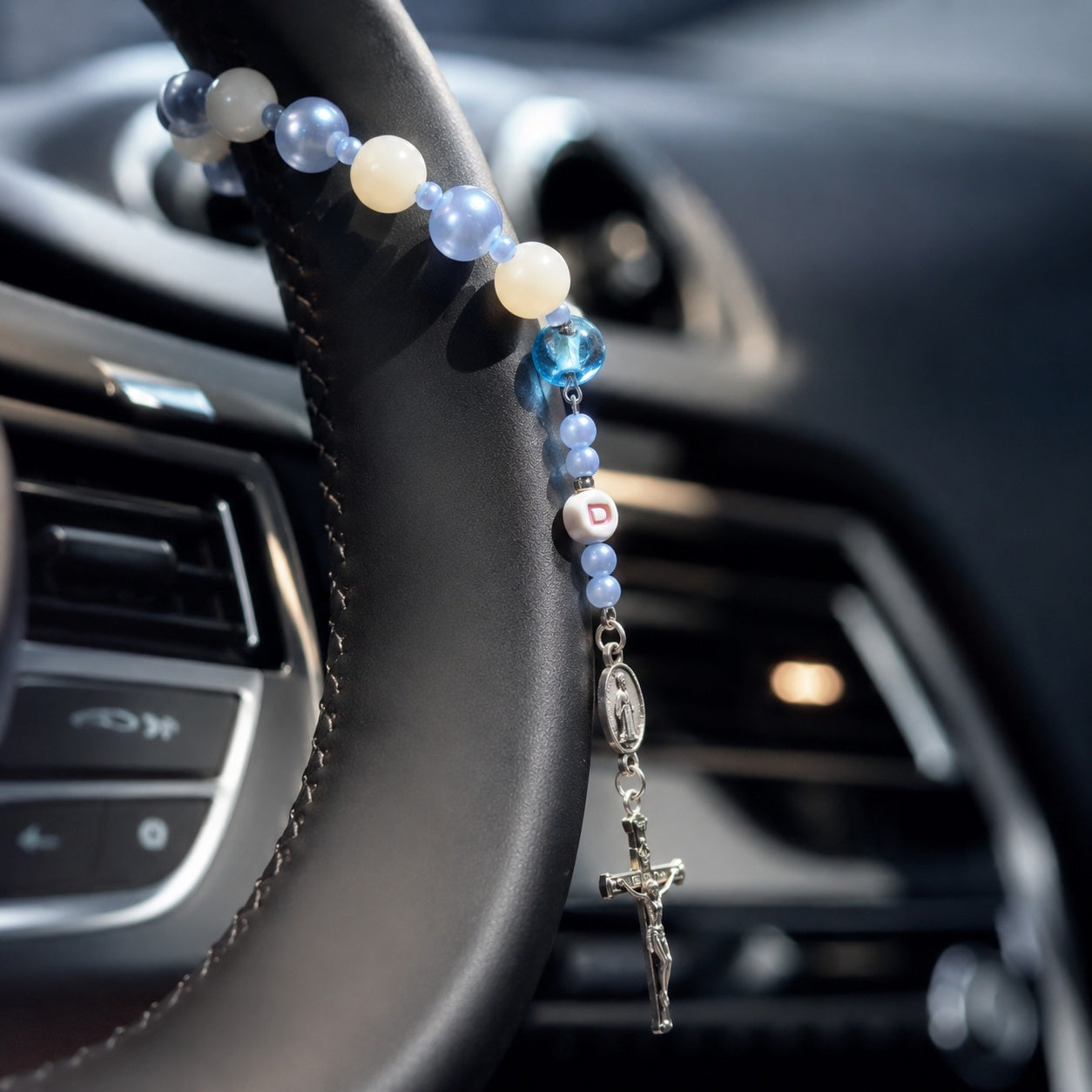 Elegant blue Catholic car rosary featuring pearl-style beads, personalized letter bead, Miraculous Medal, and silver crucifix for a car blessing gift