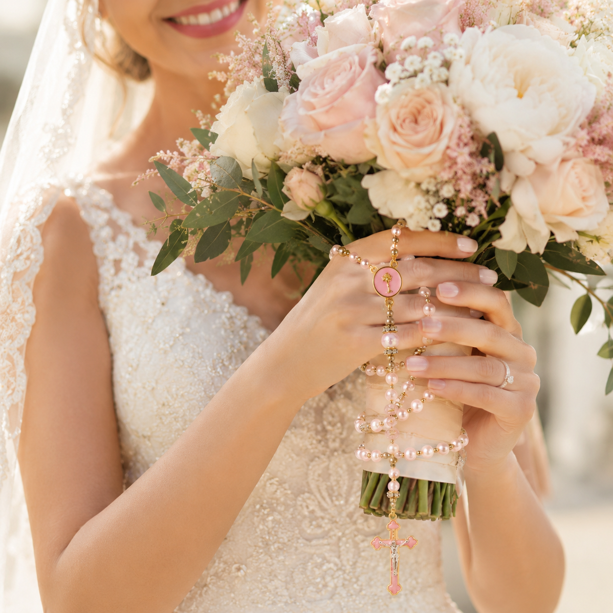 Catholic wedding rosary for bride with pink pearl beads, gold-tone details, and a delicate crucifix for bouquet styling