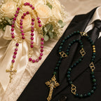 Bride and groom matching Catholic rosaries displayed together with wedding rings, symbolizing faith, love, and marriage commitment