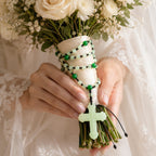 Sage green Catholic wedding rosary with jade-style beads and cross displayed on a bridal bouquet, a meaningful prayer keepsake for a bride’s church wedding.