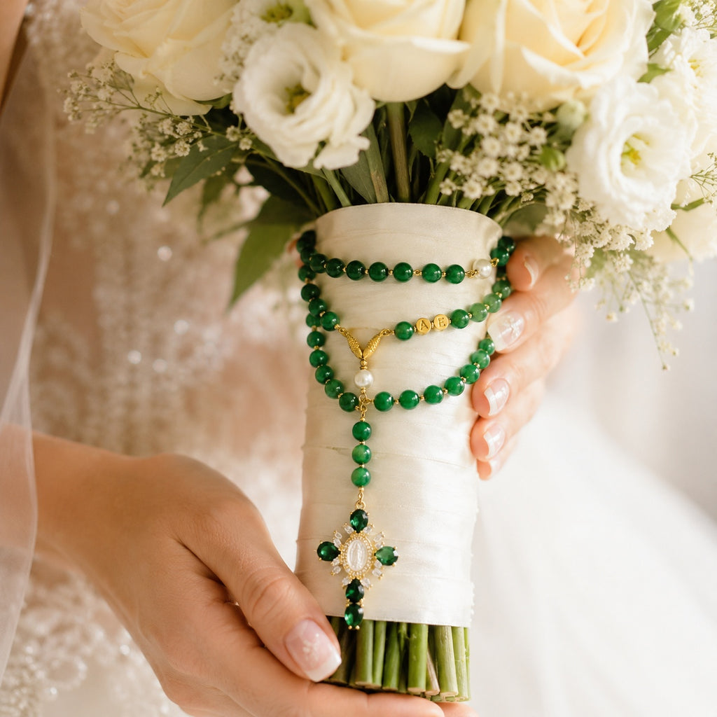 Bridal bouquet rosary with emerald green beads, gold-tone accents, pearl details, and a decorative Catholic cross pendant for wedding day prayer