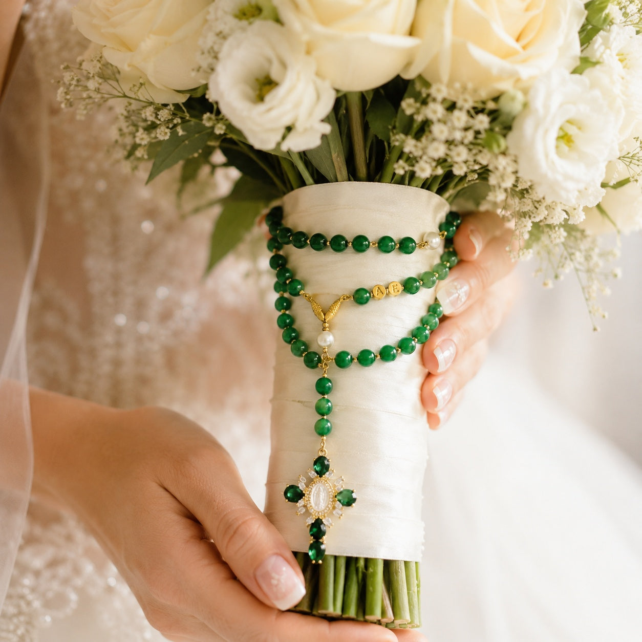 Bridal bouquet rosary with emerald green beads, gold-tone accents, pearl details, and a decorative Catholic cross pendant for wedding day prayer