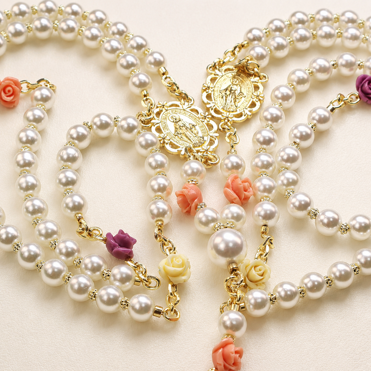 Handmade pearl Catholic wedding rosary with floral accents, gold Marian medals, and large pearl cross pendant for bridal lasso ceremony.