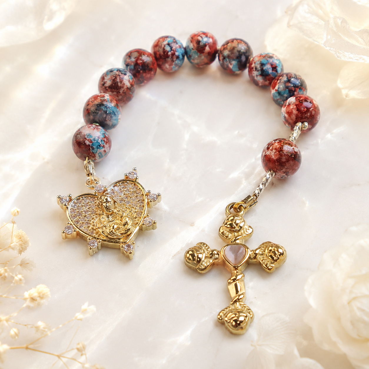 Handmade Catholic prayer beads with colorful gemstone beads, religious centerpiece, and cross pendant designed as a portable prayer companion.