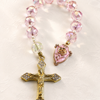 Pink crystal Catholic prayer beads with pearl accents, gold crucifix, and religious centerpiece designed as a meaningful faith gift.