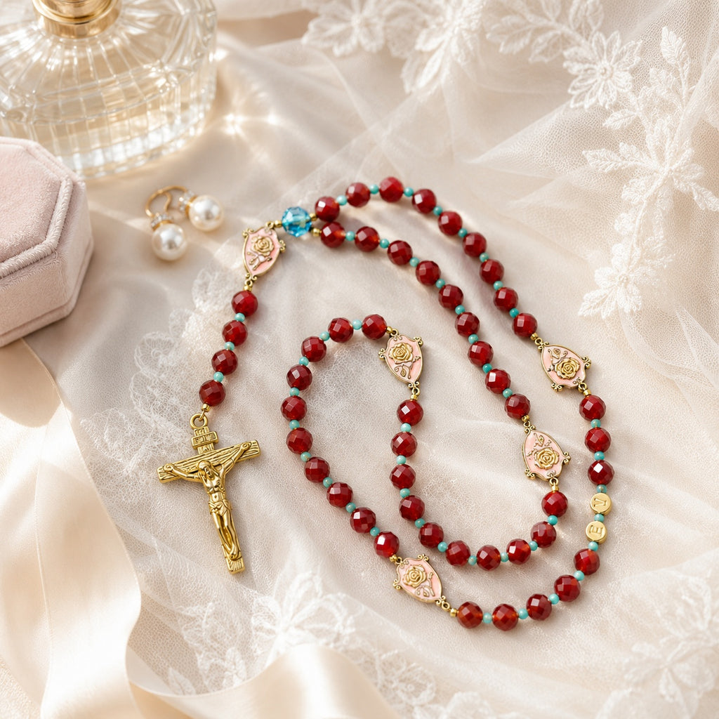 Bride holding a burgundy Catholic rosary with gold crucifix and rose medals, symbolizing faith, love, and marriage blessing