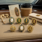 Multiple styles of Catholic car vent clips with Virgin Mary medals, crystal accents, gold-tone details, and cross faith designs