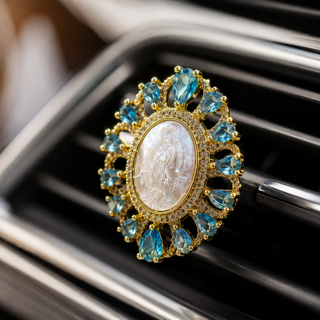 Close-up of a Virgin Mary religious car vent clip featuring blue crystal accents, gold tone design, and Catholic faith symbolism