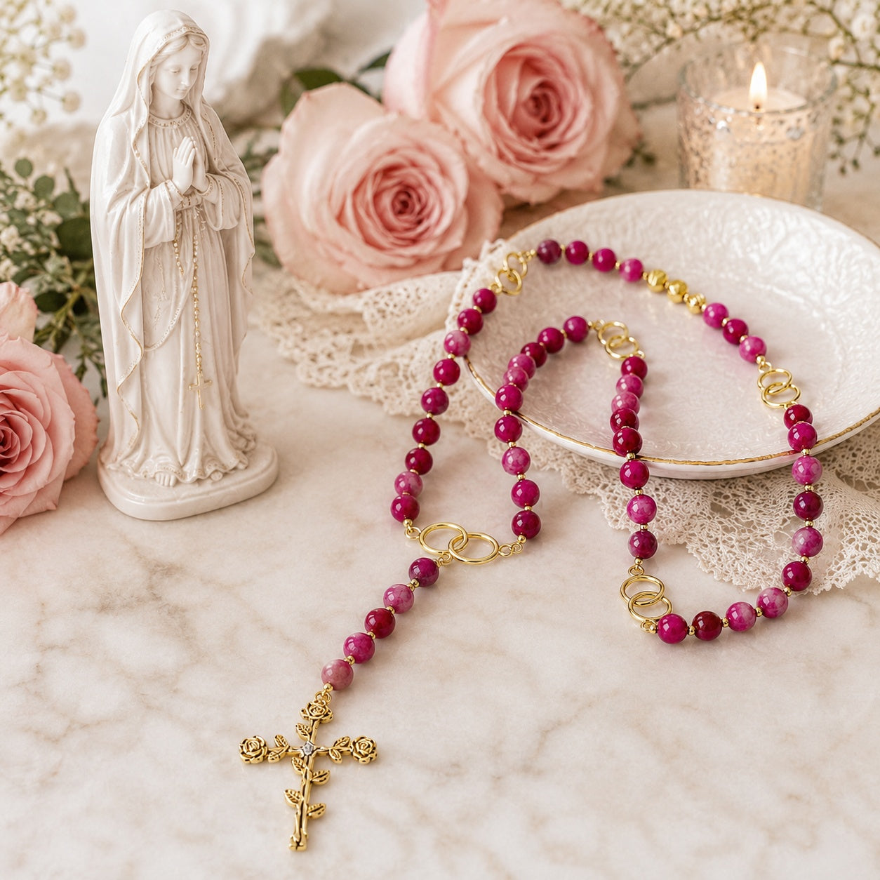Handmade gemstone Catholic rosary for women with pink natural stone beads and gold tone crucifix on elegant white background