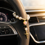 Catholic steering wheel rosary with pearl-style beads and gold crucifix, designed as a meaningful faith accessory for drivers