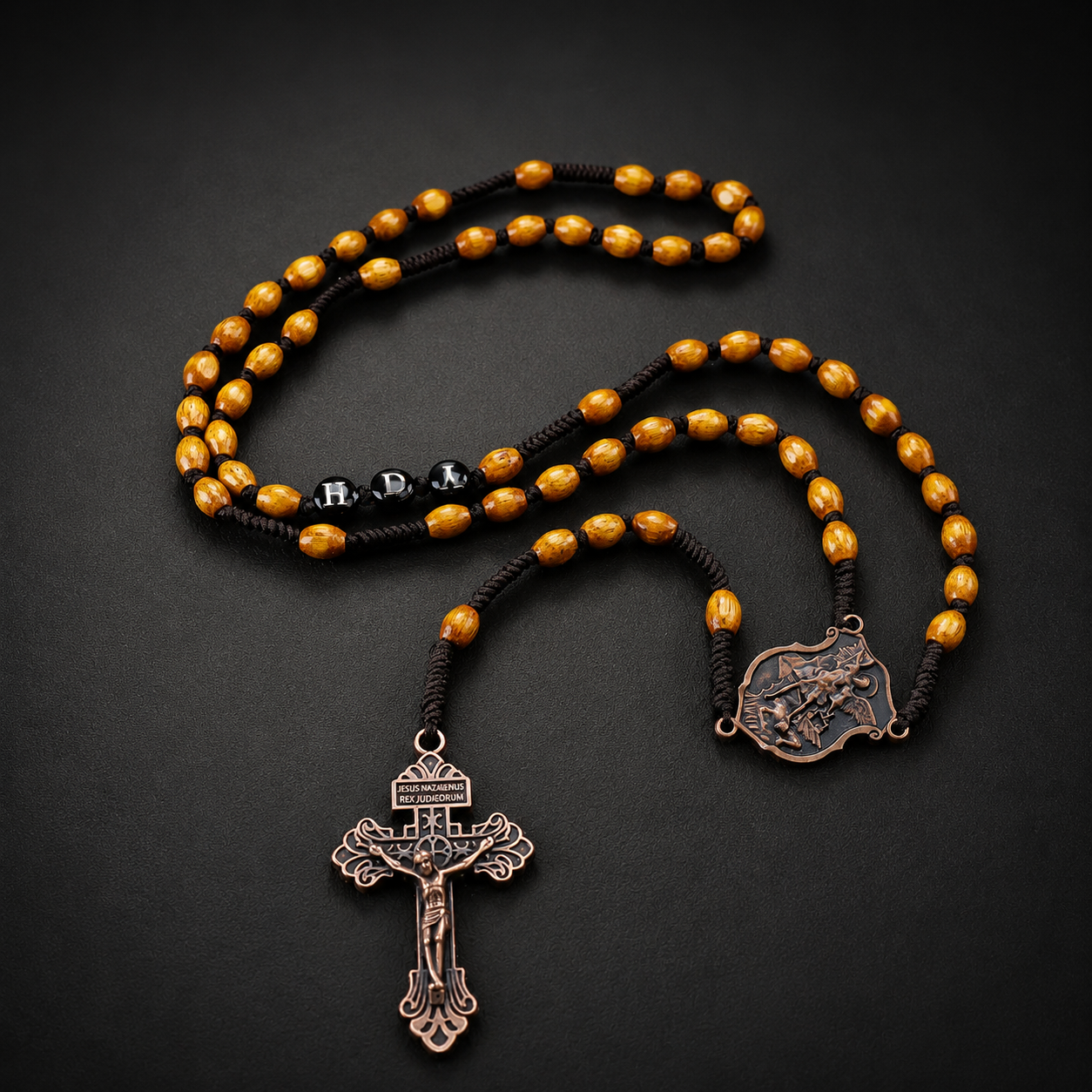 Handmade men's wooden Catholic rosary with brown beads, dark woven cord, and antique bronze crucifix for daily prayer and devotion.