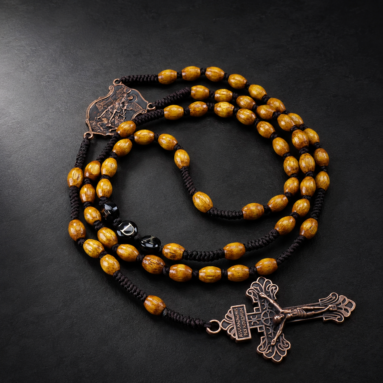 Men's rustic Catholic rosary featuring wooden-style beads, antique bronze religious centerpiece, and crucifix for prayer and reflection.