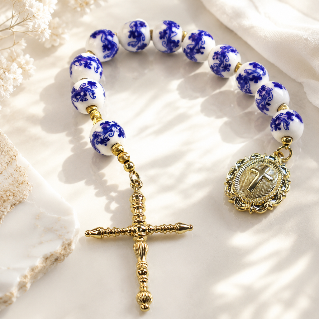 Blue and white Catholic prayer beads featuring ceramic-style beads, religious medal, and crucifix for personal devotion and spiritual reflection.