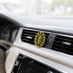 Catholic Virgin Mary car vent clip displayed on a luxury white car interior with green religious charm details