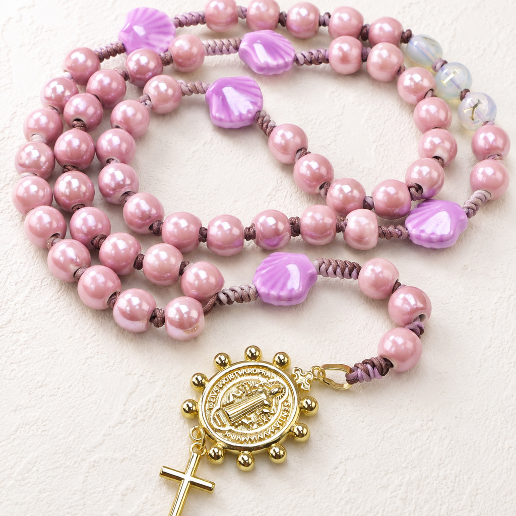 Handmade seashell Catholic rosary with shell-shaped beads, soft coastal colors, religious centerpiece, and cross pendant for daily prayer.