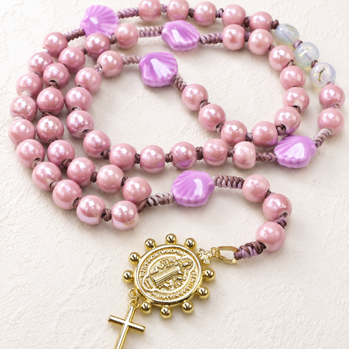 Handmade seashell Catholic rosary with shell-shaped beads, soft coastal colors, religious centerpiece, and cross pendant for daily prayer.