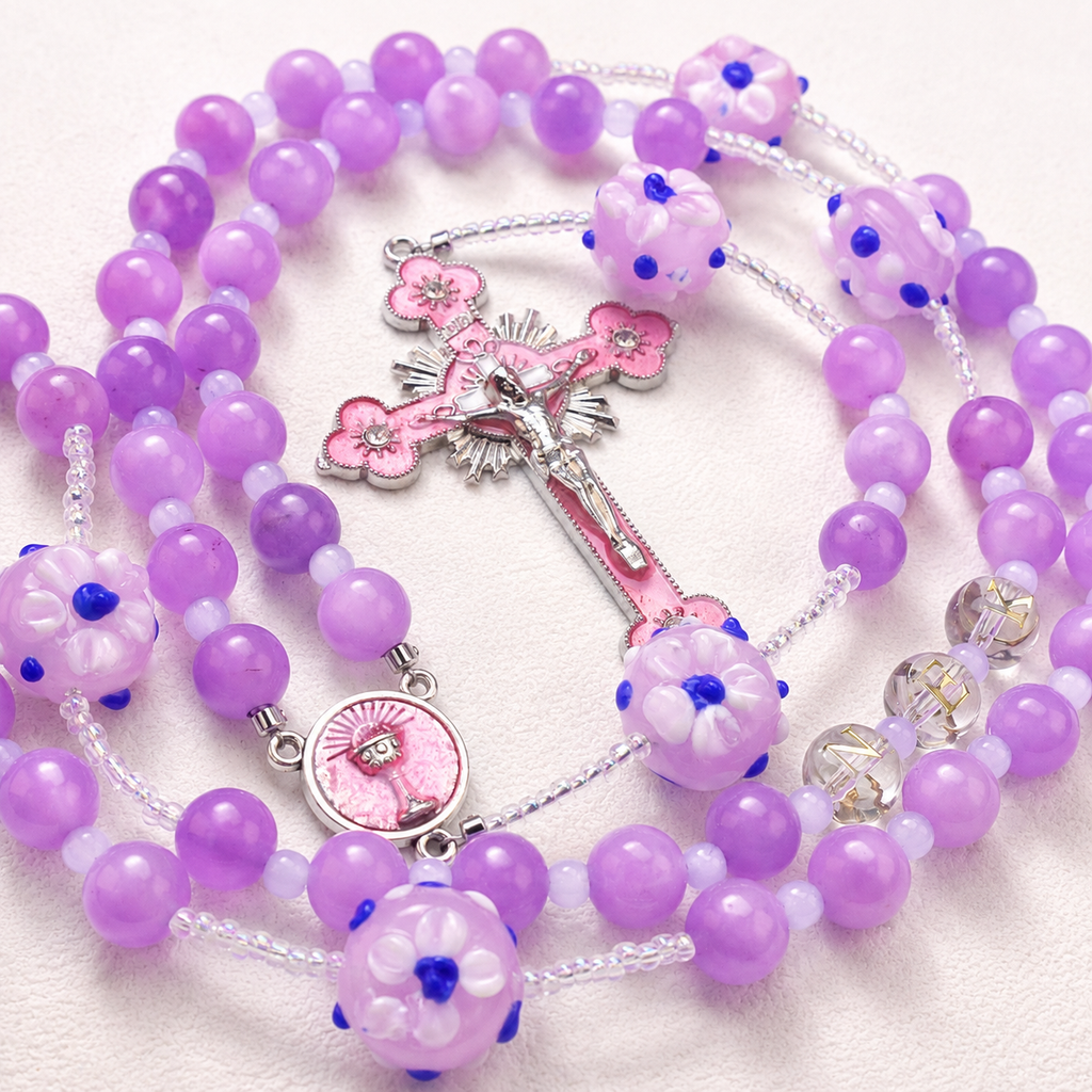 Handmade lavender Catholic rosary featuring soft purple beads, floral details, and a delicate crucifix design.