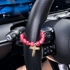 Red bead Catholic car rosary charm with gold crucifix pendant, a handmade Christian car accessory symbolizing faith and protection.