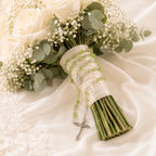 Catholic bridal bouquet rosary with green prayer beads, silver-tone crucifix, and elegant wedding floral styling