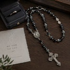 Elegant men’s Catholic rosary with dark prayer beads, silver-tone crucifix, and Marian medal styled for a groom wedding gift