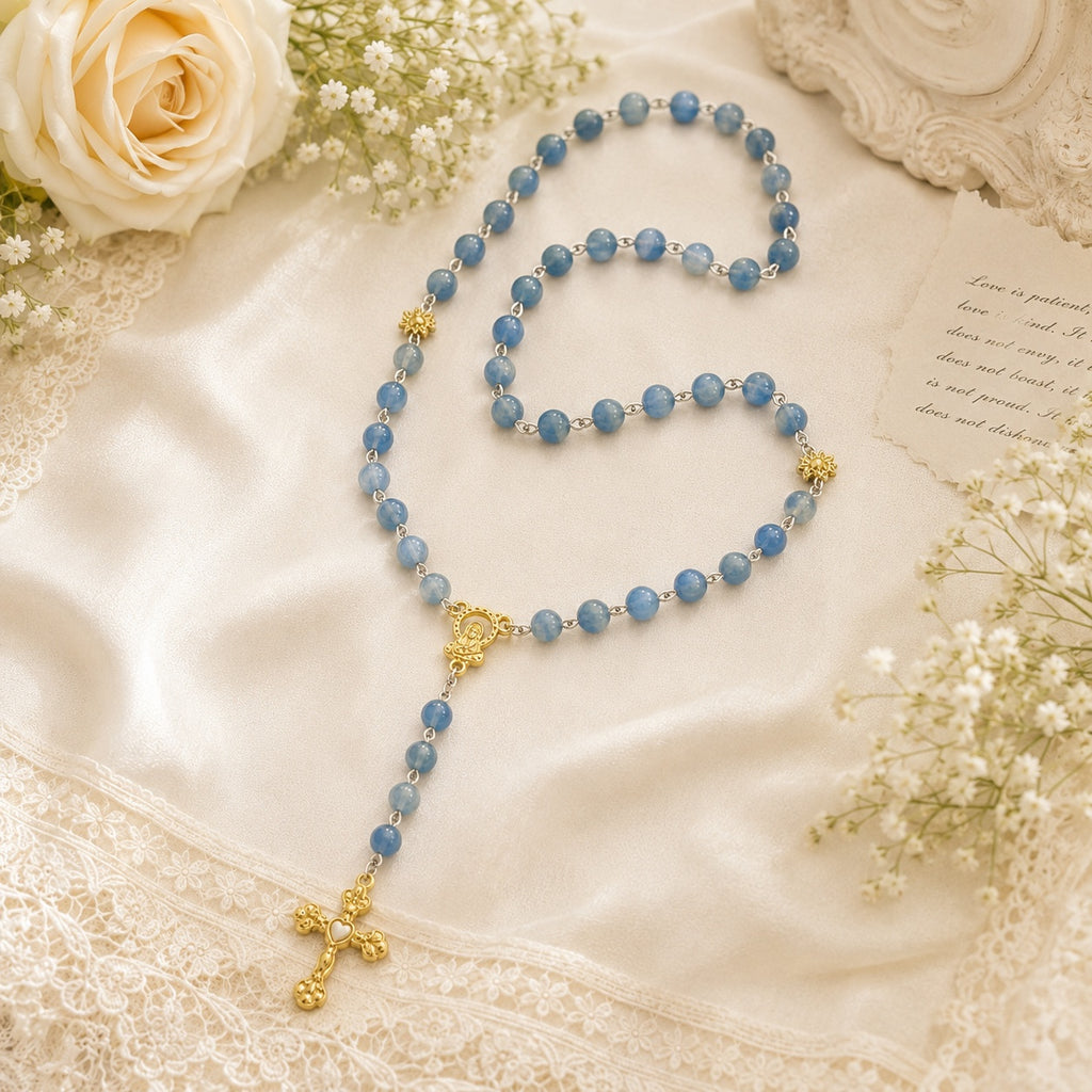 Something Blue wedding rosary hanging on a church pew with white ribbon and flowers, a Catholic bride gift for marriage blessing
