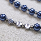 Personalized blue Catholic rosary with elegant prayer beads, religious medals, and silver crucifix designed as a meaningful faith gift.